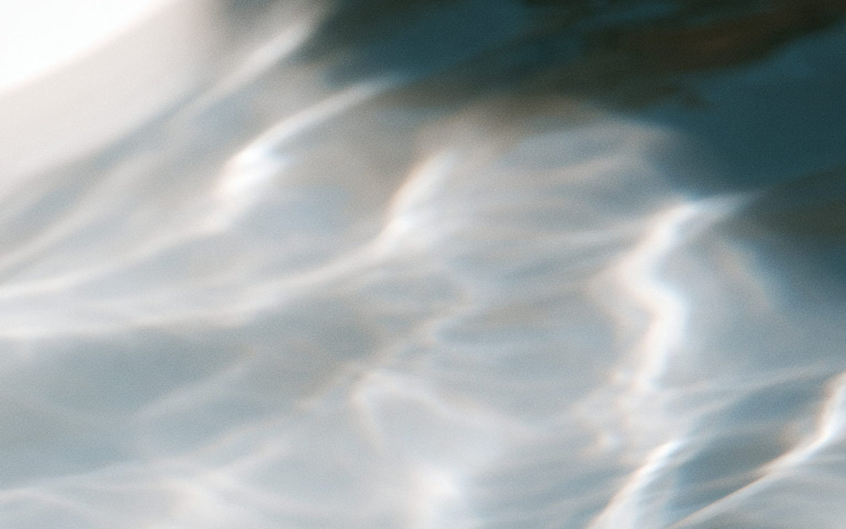 Pale blue ripples across the surface of a pool in bright sun